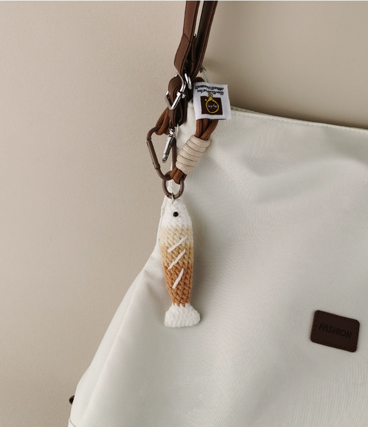 Handmade red crochet Fortune Fish keychain with a golden hanging cord and lobster clasp, displayed on a soft neutral background. A symbol of luck and abundance, inspired by the Chinese saying "年年有鱼".