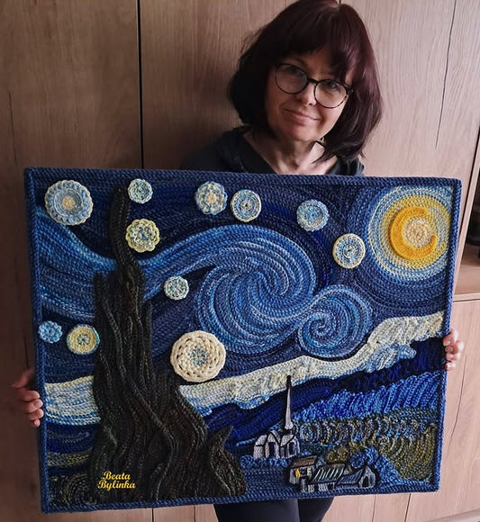 A woman holding up an artwork depicting the starry night, painted in the style of crochet and yarn art. The highly detailed, beautiful masterpiece is a crochet wool painting. 