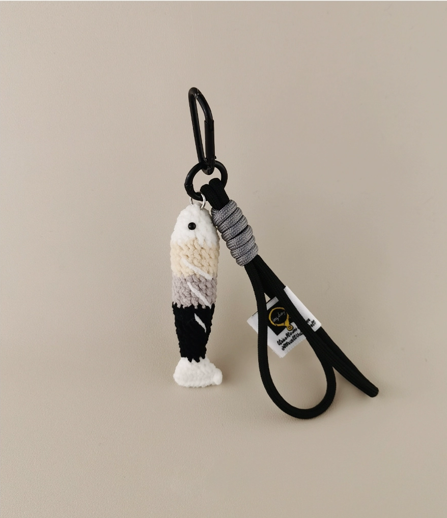 Handmade red crochet Fortune Fish keychain with a golden hanging cord and lobster clasp, displayed on a soft neutral background. A symbol of luck and abundance, inspired by the Chinese saying "年年有鱼".