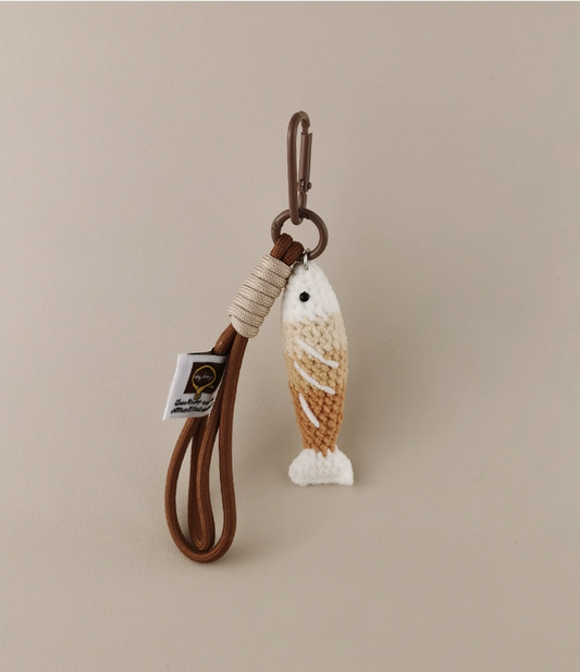 Handmade red crochet Fortune Fish keychain with a golden hanging cord and lobster clasp, displayed on a soft neutral background. A symbol of luck and abundance, inspired by the Chinese saying "年年有鱼".