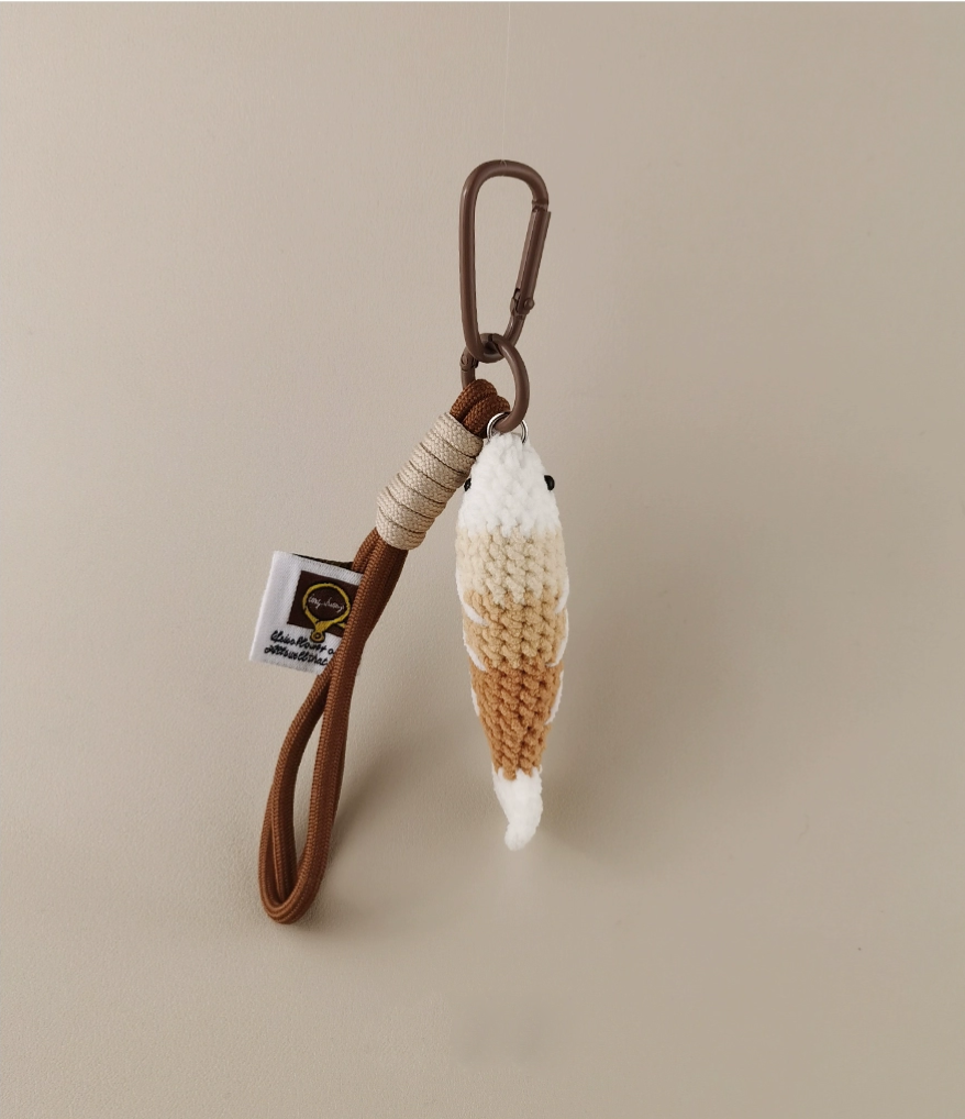 Handmade red crochet Fortune Fish keychain with a golden hanging cord and lobster clasp, displayed on a soft neutral background. A symbol of luck and abundance, inspired by the Chinese saying "年年有鱼".