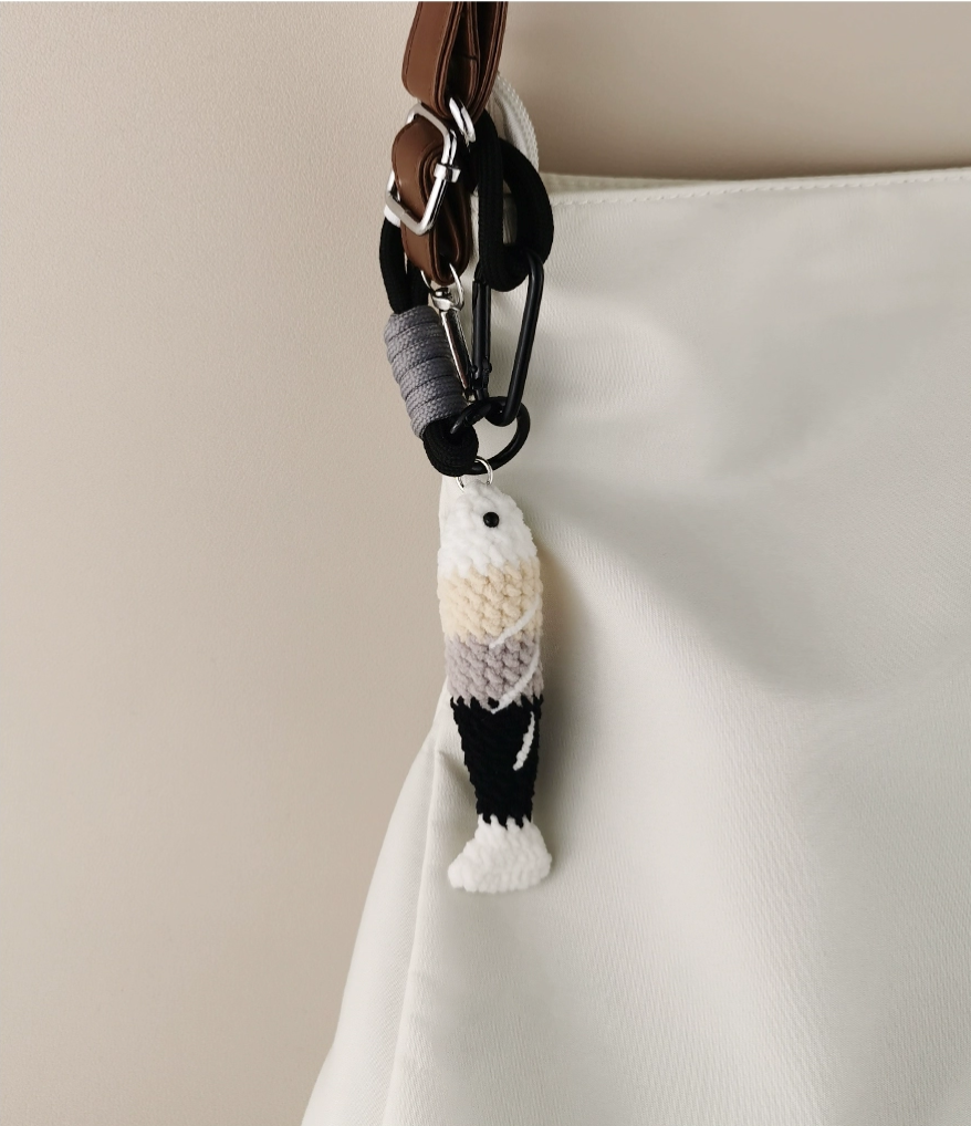 Handmade red crochet Fortune Fish keychain with a golden hanging cord and lobster clasp, displayed on a soft neutral background. A symbol of luck and abundance, inspired by the Chinese saying "年年有鱼".
