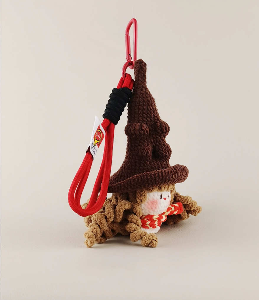  A cute wizard in an amigurumi style, sitting on its bottom with a red leash hanging down from the back of its head and wearing a brown hat, product shot on a white background, product photography. 